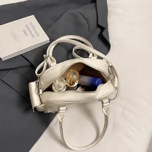 Detail view of cream white bowling bag interior showing capacity for daily essentials