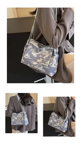 Detail of blue and white landscape print shoulder bag with silver chain strap