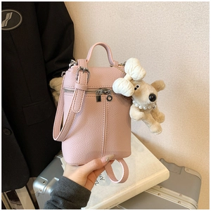 Detail of pink lychee pattern mini backpack with a cute plush dog pendant accessory