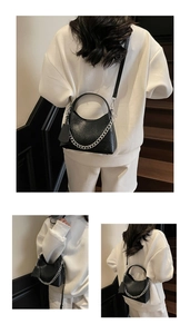 Detail of black lychee texture bucket bag with silver chain strap and crescent moon shape