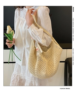 Detailed close-up of woven tote bag with pink floral lace ribbon and hollow pattern