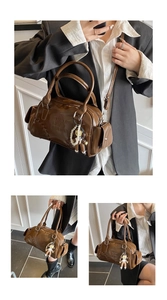Detail of coffee brown bowling bag with embossed letters and a cute bear charm