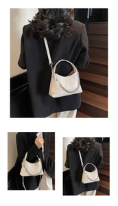 Detail of cream white lychee texture bucket bag with silver chain and crossbody strap