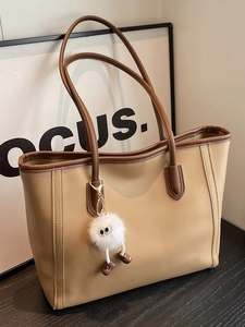 Minimalist two-tone khaki tote bag with dark brown handles and cute plush charm pendant