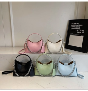 Detailed display of five colorful lychee textured bucket bags with silver chain decor