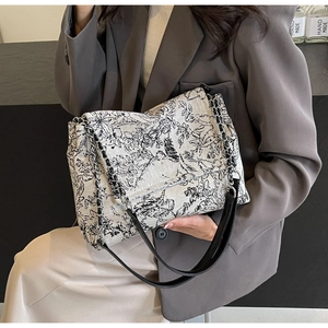 Detailed view of canvas tote bag featuring classic black and white Toile de Jouy landscape print