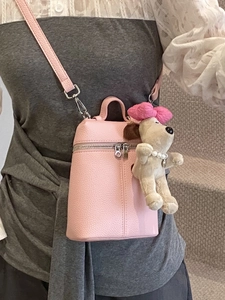Pink lychee grain cylinder bag with cute puppy pendant and long leather shoulder strap