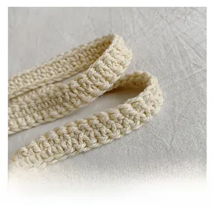 Detail of hand-woven cream cotton strap with intricate crochet texture and soft finish