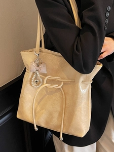 Borsa tote beige in pelle cerata con coulisse e ciondolo a cuore con perla