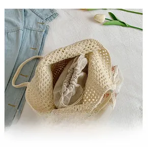 Detail of the woven tote bag featuring a spacious main compartment and floral drawstring inner bag