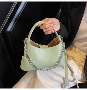 Detail view of mint green lychee pattern leather bucket bag with silver chain
