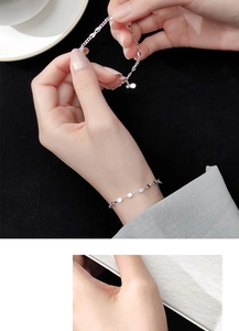 Close-up of minimalist S925 sterling silver geometric leaf chain bracelet on female wrist