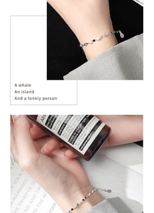 Close-up of minimalist S925 sterling silver geometric link bracelet with water drop pendant