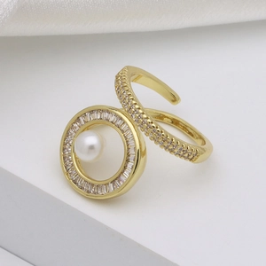 Elegant gold open ring with white pearl centerpiece and zircon halo on luxury silk background