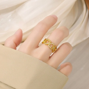 Golden hollow heart ring with zircon micro-paving for women worn on index finger