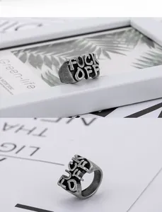 Detailed close-up of retro titanium steel ring featuring hollow Fuck Off letter design