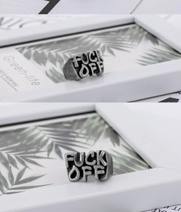 Detailed view of vintage silver steel ring featuring hollowed Fuck Off letter design