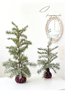 Mini snowy Christmas tree set with natural pine cones and festive snowflake fabric base
