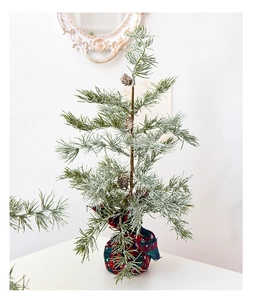 Miniature artificial Christmas tree with pine cones and red-green plaid base decor