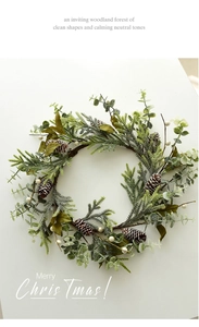 Detail of Christmas wreath with pine cones, green needles, and white berries decoration