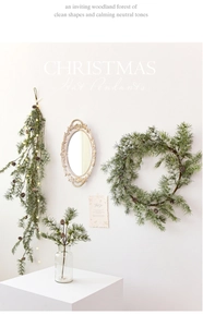 Detailed view of glowing pine needle garland with warm LED lights and pine cones
