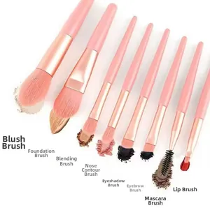 Macro shot of 8-piece pink makeup brush set with rose gold ferrules and soft fiber bristles