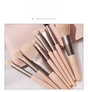 Close-up of 8pcs pink makeup brush set with champagne gold ferrules and leather pouch