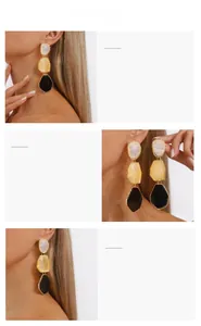 Detail view of geometric resin drop earrings with gold metal edges and colorful segments