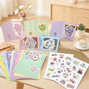 Detail of laser-cut floral birthday cards and decorative stickers on a cozy wooden table