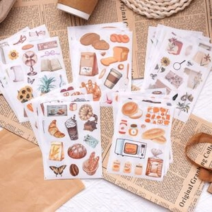 Close-up of vintage aesthetic scrapbooking stickers with coffee and bakery illustrations