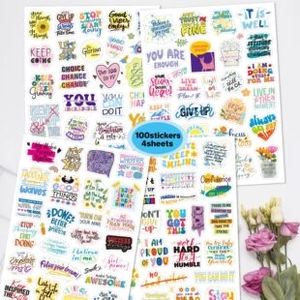 Close-up of 100-piece inspirational quote stickers with colorful fonts on white surface
