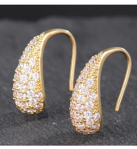 Macro close-up of waterdrop earrings featuring sparkling zircons on elegant golden fish hooks