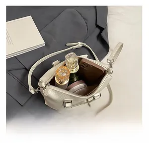 Interior view of off-white lychee grain leather handbag showing spacious capacity