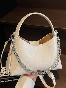 Minimalist cream white lychee texture bucket bag with chunky silver chain and strap