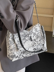 Chic canvas tote bag with black and white floral pattern and metal chain strap
