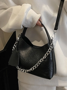 Minimalist black bucket bag with lychee texture and silver chain detail for women