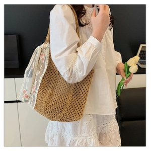 Detail of hollow woven straw tote bag with elegant floral lace ribbon decoration
