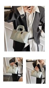 Detail of mint green PU leather boston bag showing textured finish and silver hardware