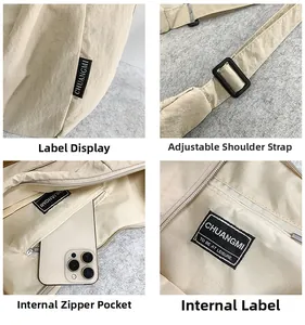 Detail view of beige nylon tote featuring adjustable buckle and internal zip pocket