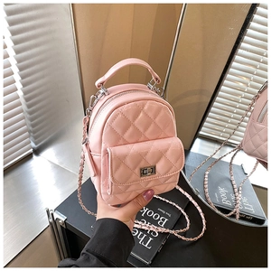 Close-up of pink quilted mini backpack featuring silver chain strap and metal clasp
