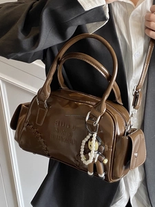 Retro dark brown shiny leather bowling bag with monkey charm and shoulder strap