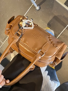 Brown vintage faux leather bowling bag with embossed lettering and cute bear charm
