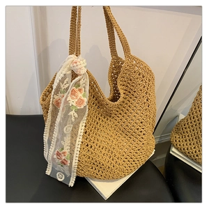Detail of woven tote bag with floral embroidery lace scarf and beach vacation style