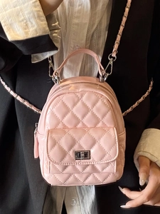 Quilted mini backpack in pink patent leather with metal chain straps and twist lock
