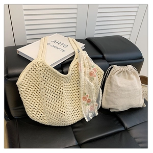 Detail of beige hollow woven tote bag with floral pink scarf and linen drawstring liner