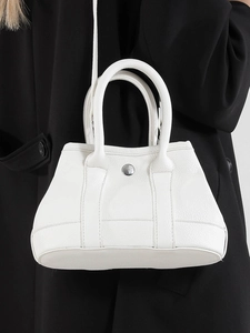 Elegant white litchi grain leather tote bag for women with silver buckle and top handle