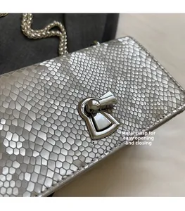 Detailed macro view of the silver fish scale texture leather and metal twist lock