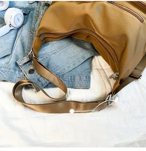Detail des verstellbaren breiten Schultergurts und des Reißverschluss-Designs an der Tasche