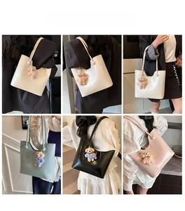 Detail shots showing high-gloss leather tote bags in white black pink and light blue with bear charm