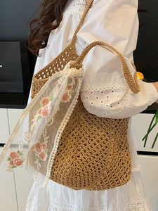 Artistic woven tote bag in wood-tone with floral lace scarf, displayed on shoulder